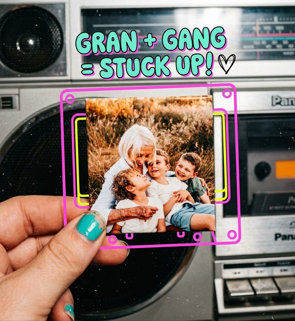 A hand holding a photo magnet of a gran with her grandkids, in front of a retro boombox